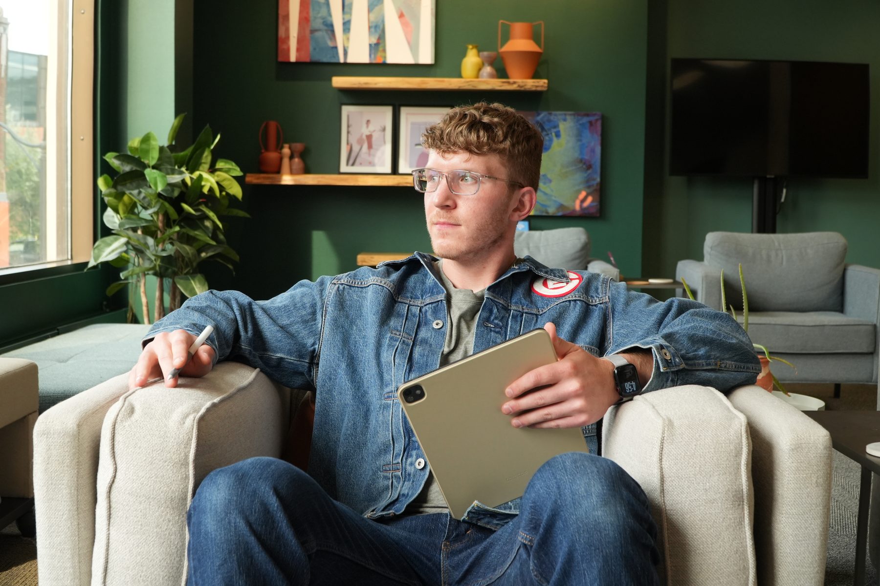 Jack Fentress, founder of Jolly Mammoth, working from a chair with an iPad